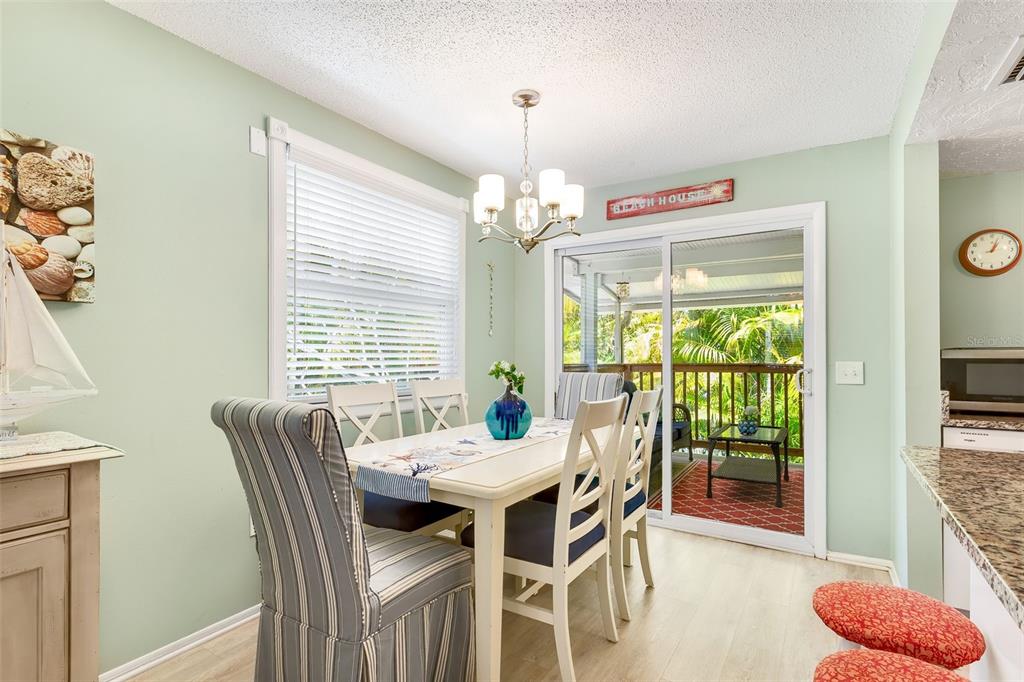 412 80th Street Holmes Beach, FL 34217 - Photo 17 of 58 a view of a dining room with furniture window and outside view