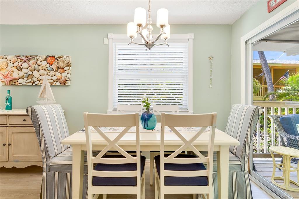412 80th Street Holmes Beach, FL 34217 - Photo 18 of 58 a view of a dining room with furniture and window