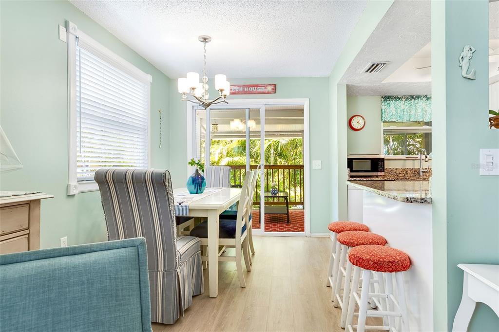 412 80th Street Holmes Beach, FL 34217 - Photo 19 of 58 a dining room with furniture window and wooden floor