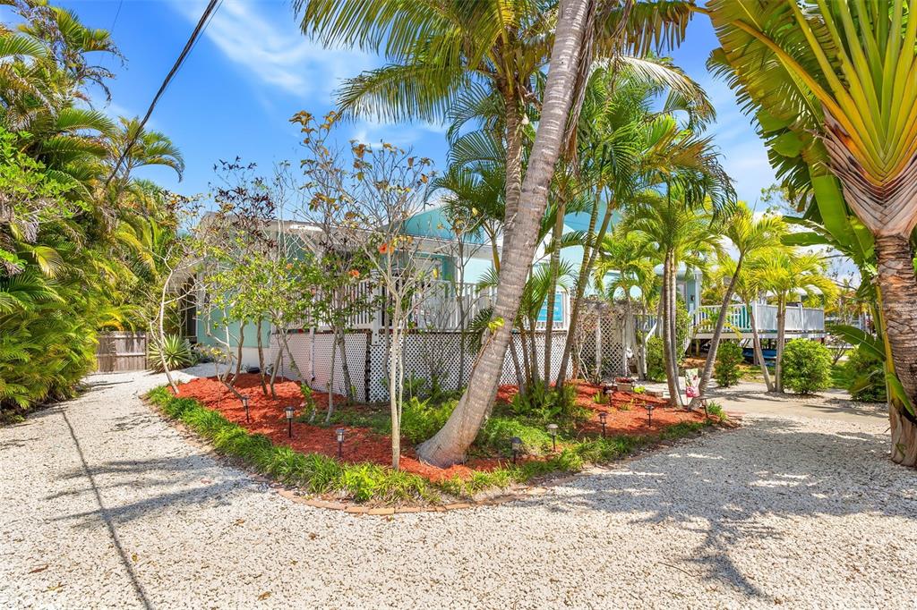 412 80th Street Holmes Beach, FL 34217 - Photo 2 of 58 a backyard of a house with table and chairs