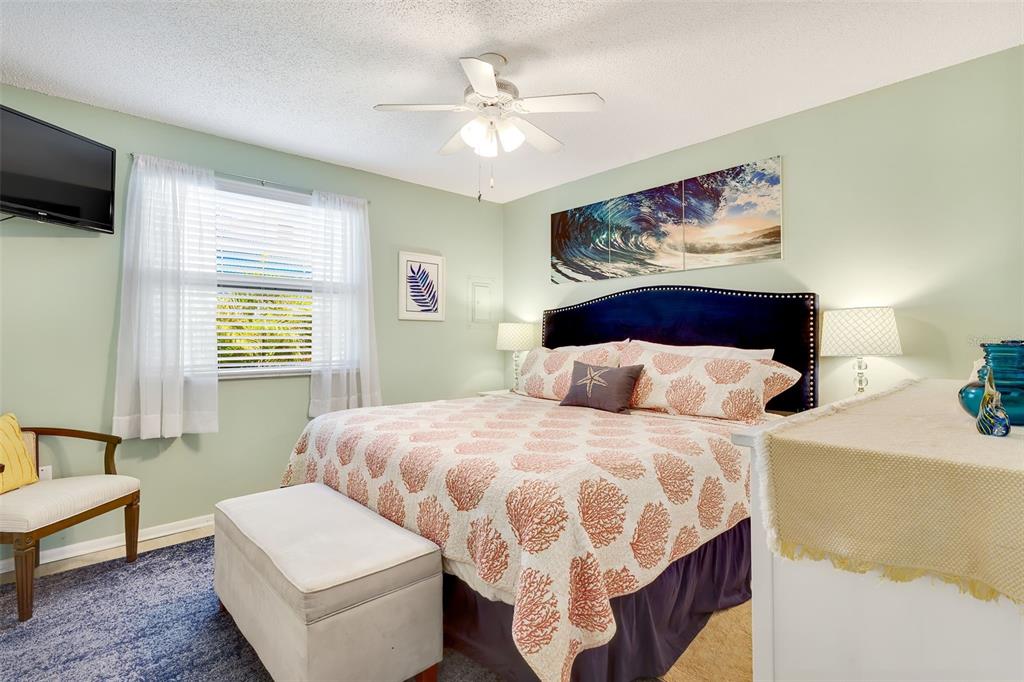 412 80th Street Holmes Beach, FL 34217 - Photo 26 of 58 a bedroom with a bed and a painting on the wall