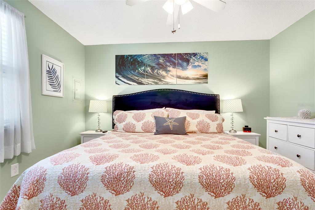 412 80th Street Holmes Beach, FL 34217 - Photo 27 of 58 a bedroom with a bed and painting on the wall