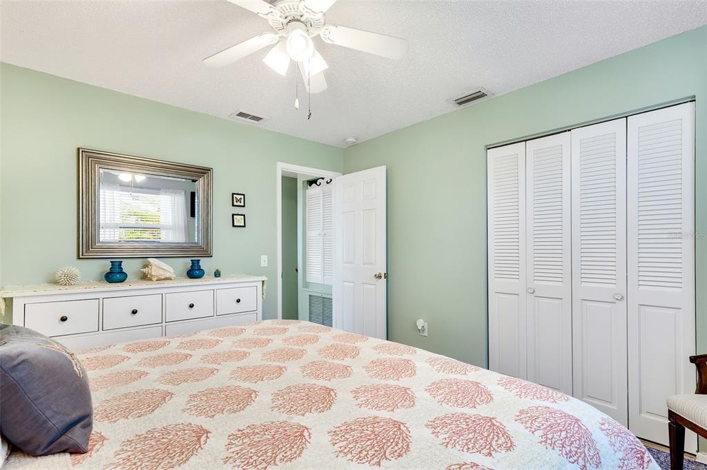 412 80th Street Holmes Beach, FL 34217 - Photo 28 of 58 a bedroom with a bed and a chandelier