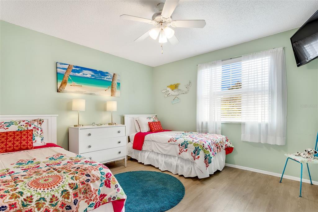 412 80th Street Holmes Beach, FL 34217 - Photo 30 of 58 a bedroom with a bed and a tv