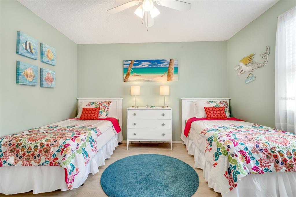 412 80th Street Holmes Beach, FL 34217 - Photo 31 of 58 a bedroom with a bed and a painting on the wall