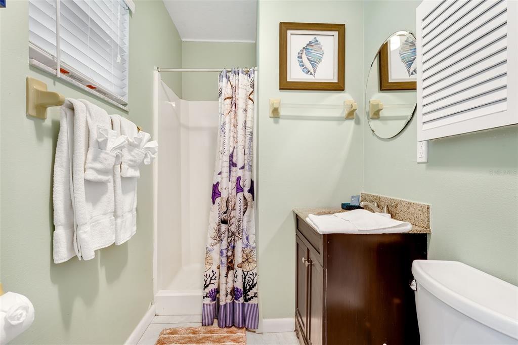 412 80th Street Holmes Beach, FL 34217 - Photo 40 of 58 a bathroom with a sink toilet and shower curtain