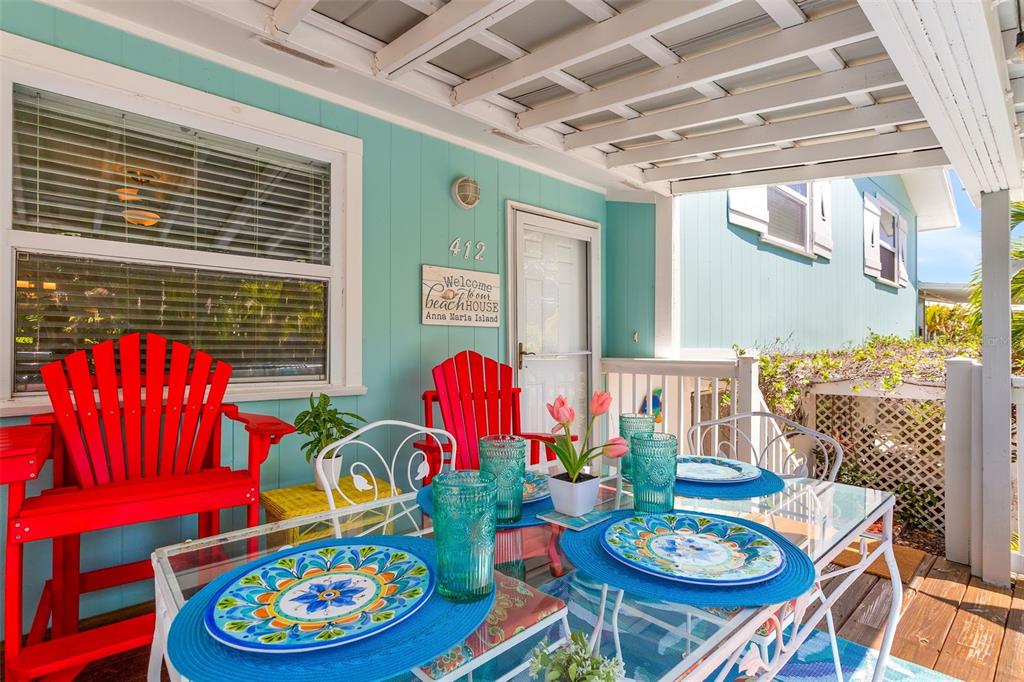 412 80th Street Holmes Beach, FL 34217 - Photo 7 of 58 a view of a dining room with furniture and a chandelier