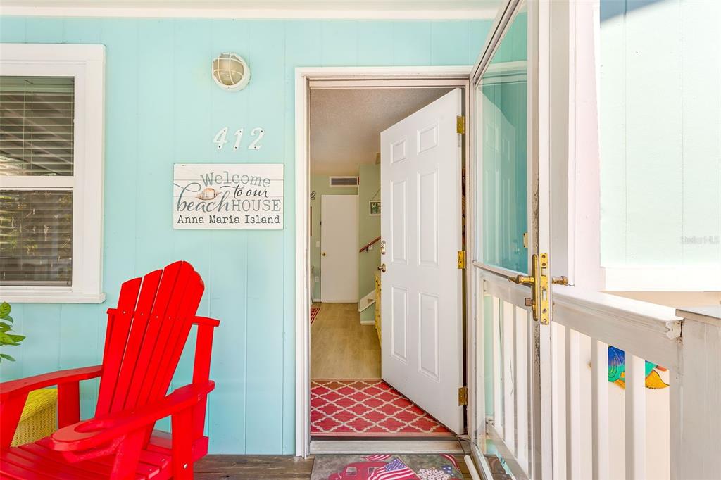 412 80th Street Holmes Beach, FL 34217 - Photo 9 of 58 a view of a hallway with chairs and a large window