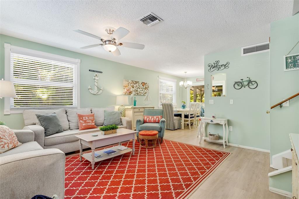 412 80th Street Holmes Beach, FL 34217 - Photo 10 of 58 a living room with furniture and a dining table