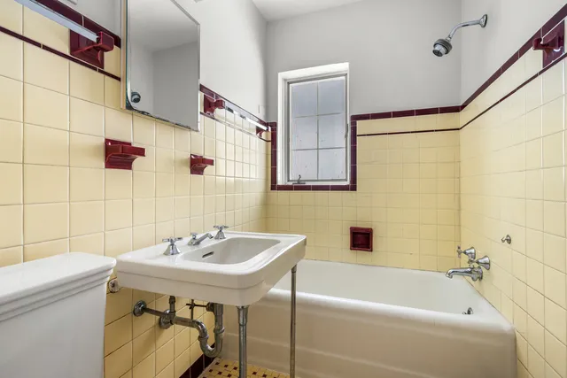 a bathroom with a sink a toilet and bathtub