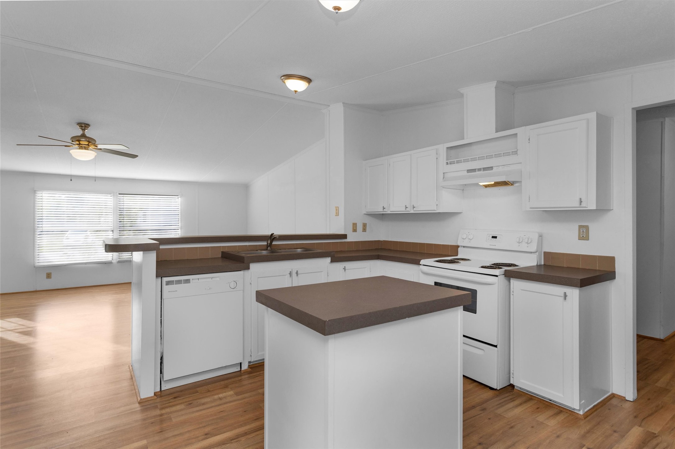 16426 Trenda Court Conroe, TX 77306 - Photo 13 of 35 a kitchen with a sink a stove cabinets and wooden floor