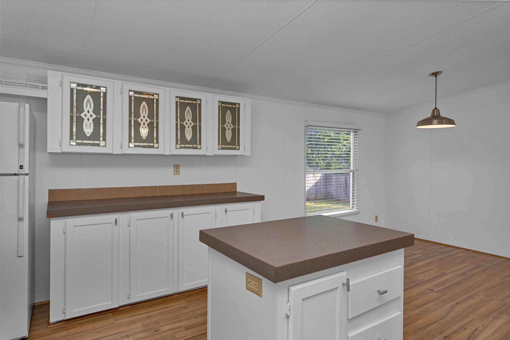 16426 Trenda Court Conroe, TX 77306 - Photo 15 of 35 a kitchen with granite countertop a stove and white cabinets with wooden floor