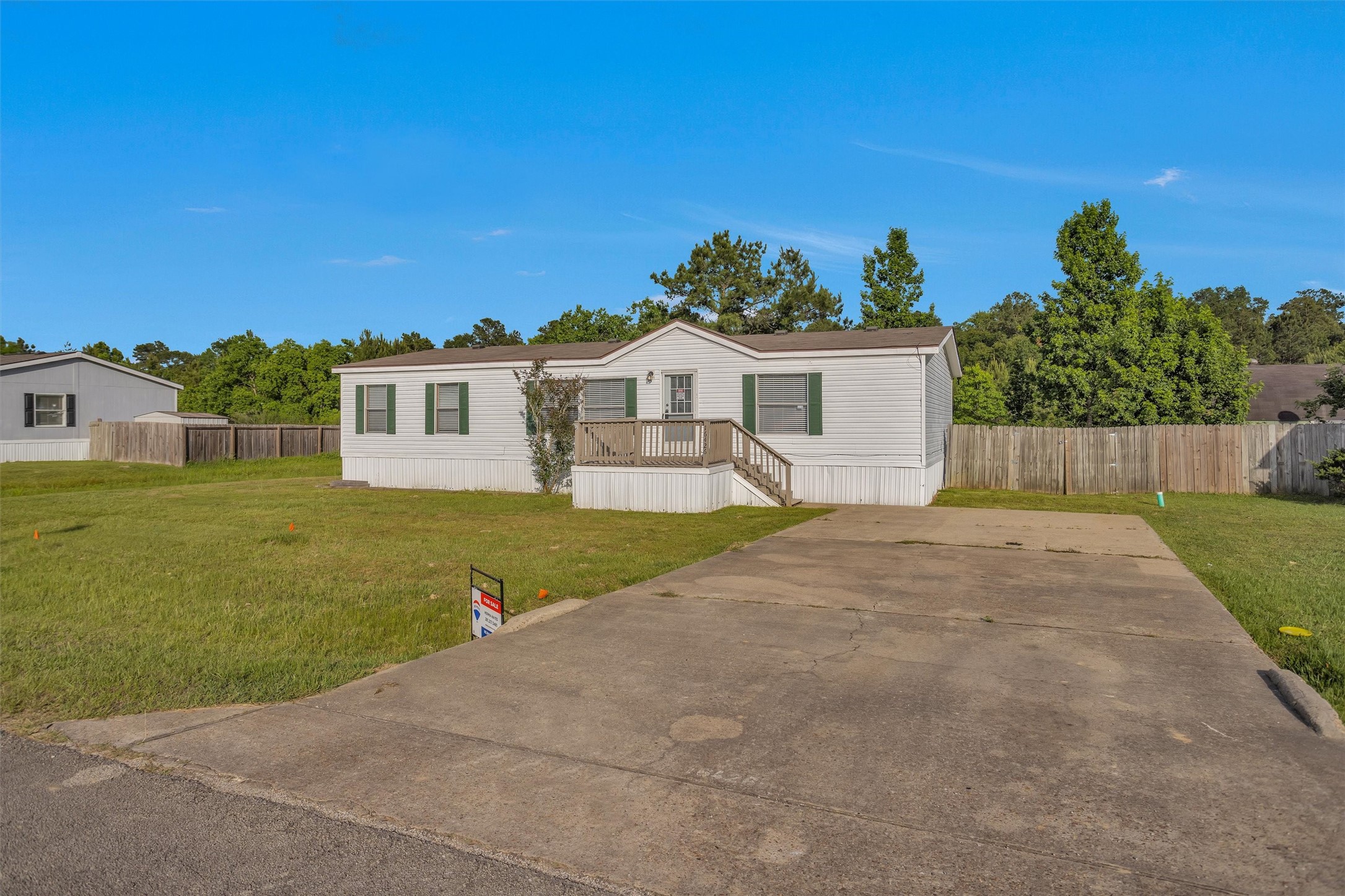 16426 Trenda Court Conroe, TX 77306 - Photo 3 of 35 a front view of a house with a yard and garage
