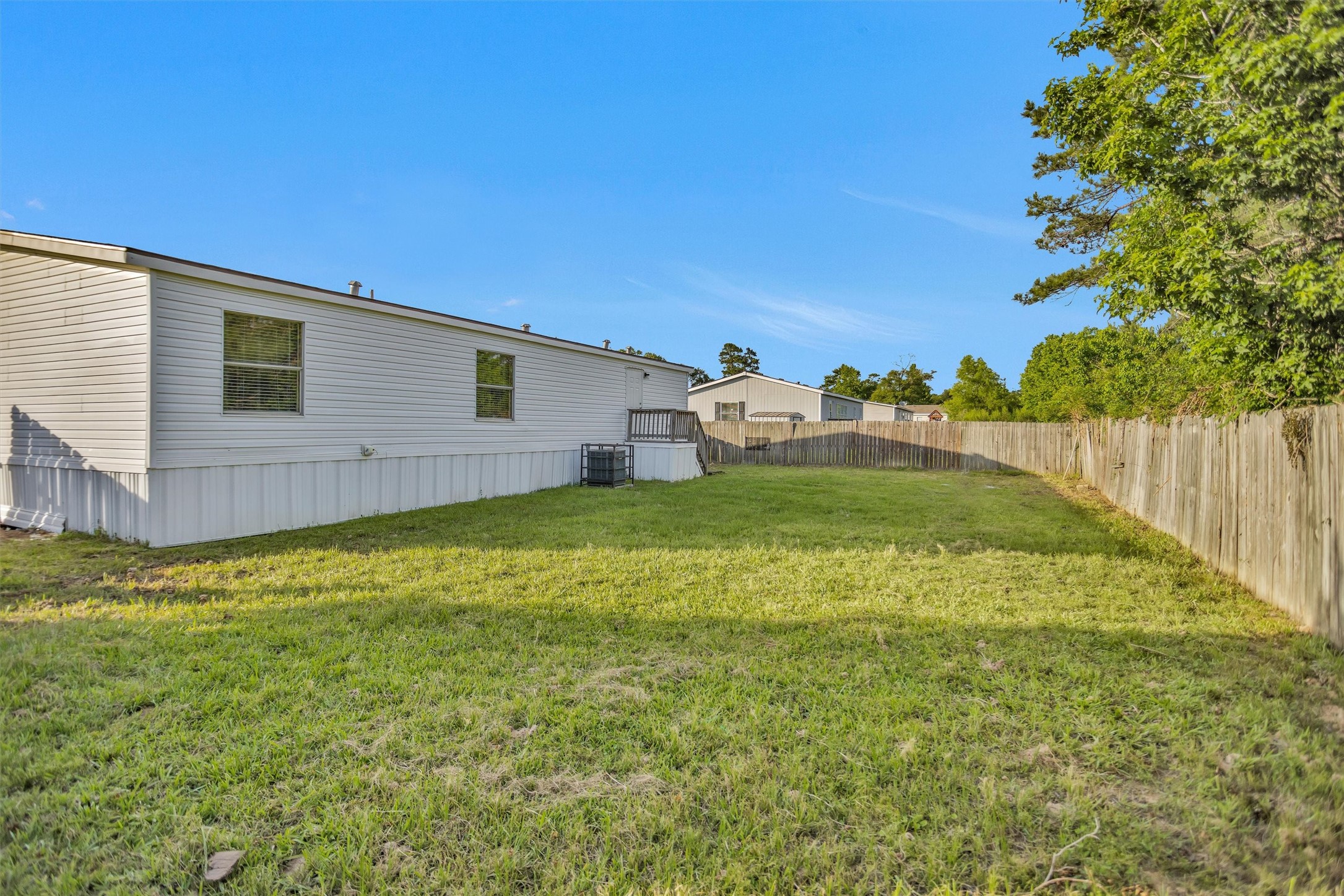 16426 Trenda Court Conroe, TX 77306 - Photo 32 of 35 a view of a backyard with plants and a bench