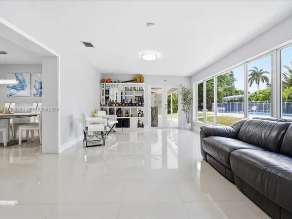 a living room with furniture and a large window