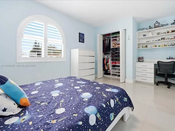 a bedroom with a bed and closet