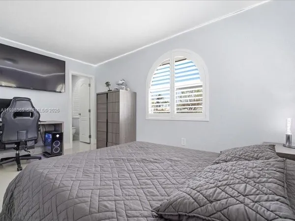 a bedroom with a bed dresser and a window