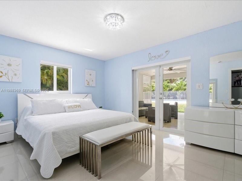 3345 Southwest 109th Court Miami, FL 33165 - Photo 25 of 41 a bedroom with a large bed and a large window