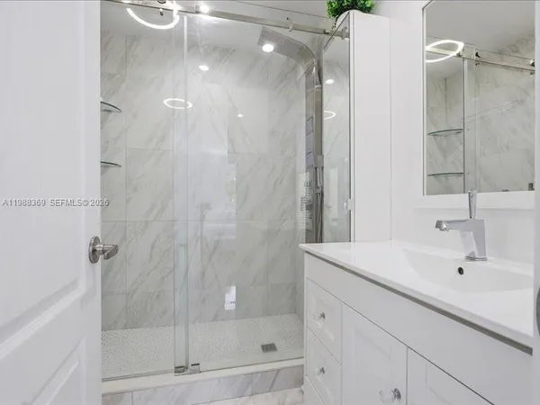 a bathroom with a shower and a sink