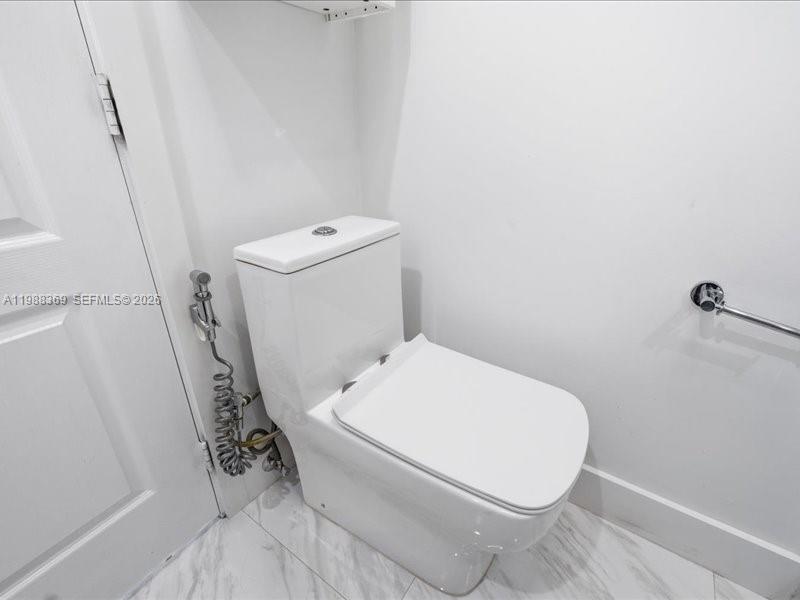 3345 Southwest 109th Court Miami, FL 33165 - Photo 29 of 41 a white toilet sitting next to a shower