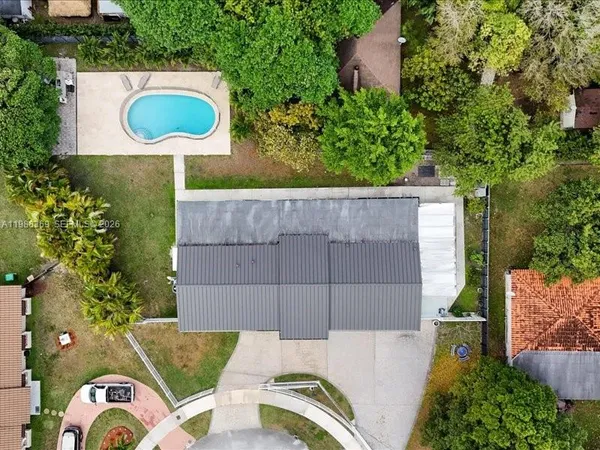 an aerial view of a house with a swimming pool
