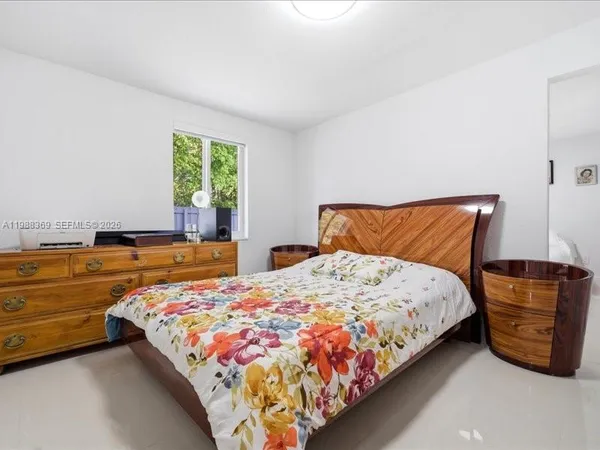a bedroom with a bed and dresser