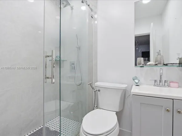 a white toilet sitting next to a bathroom sink