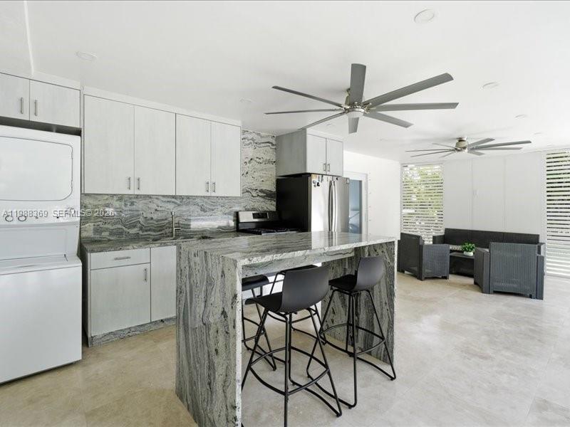 3345 Southwest 109th Court Miami, FL 33165 - Photo 37 of 41 a kitchen with stainless steel appliances granite countertop a stove a refrigerator and a refrigerator with white cabinets
