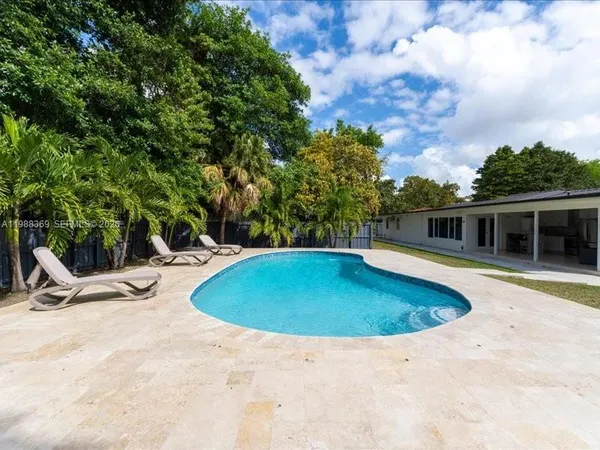 a view of a swimming pool with a yard