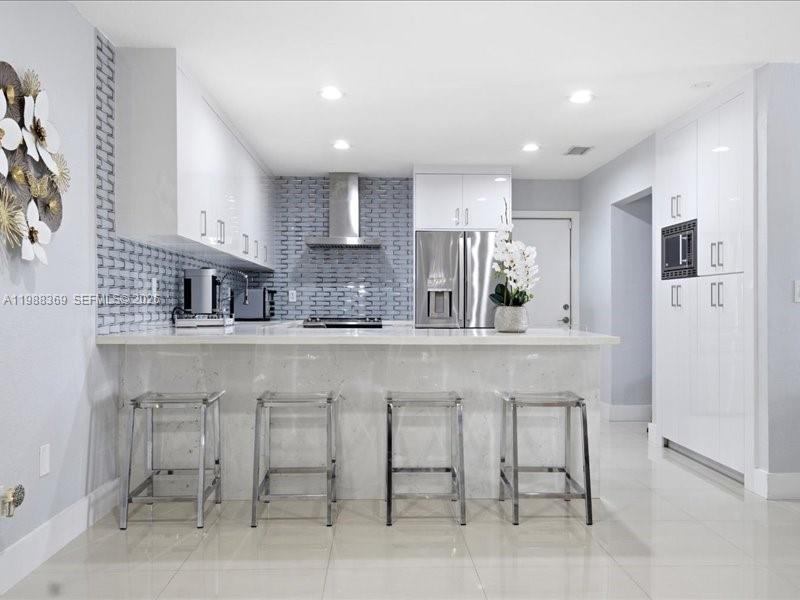 3345 Southwest 109th Court Miami, FL 33165 - Photo 10 of 41 a kitchen with cabinets and chairs