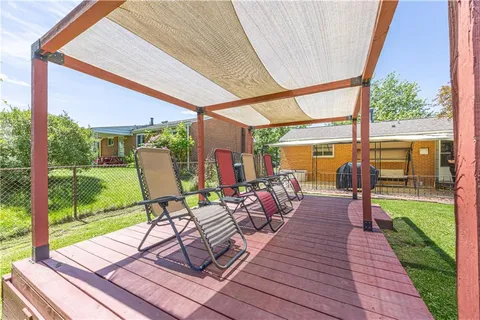 a chairs on the deck with a backyard