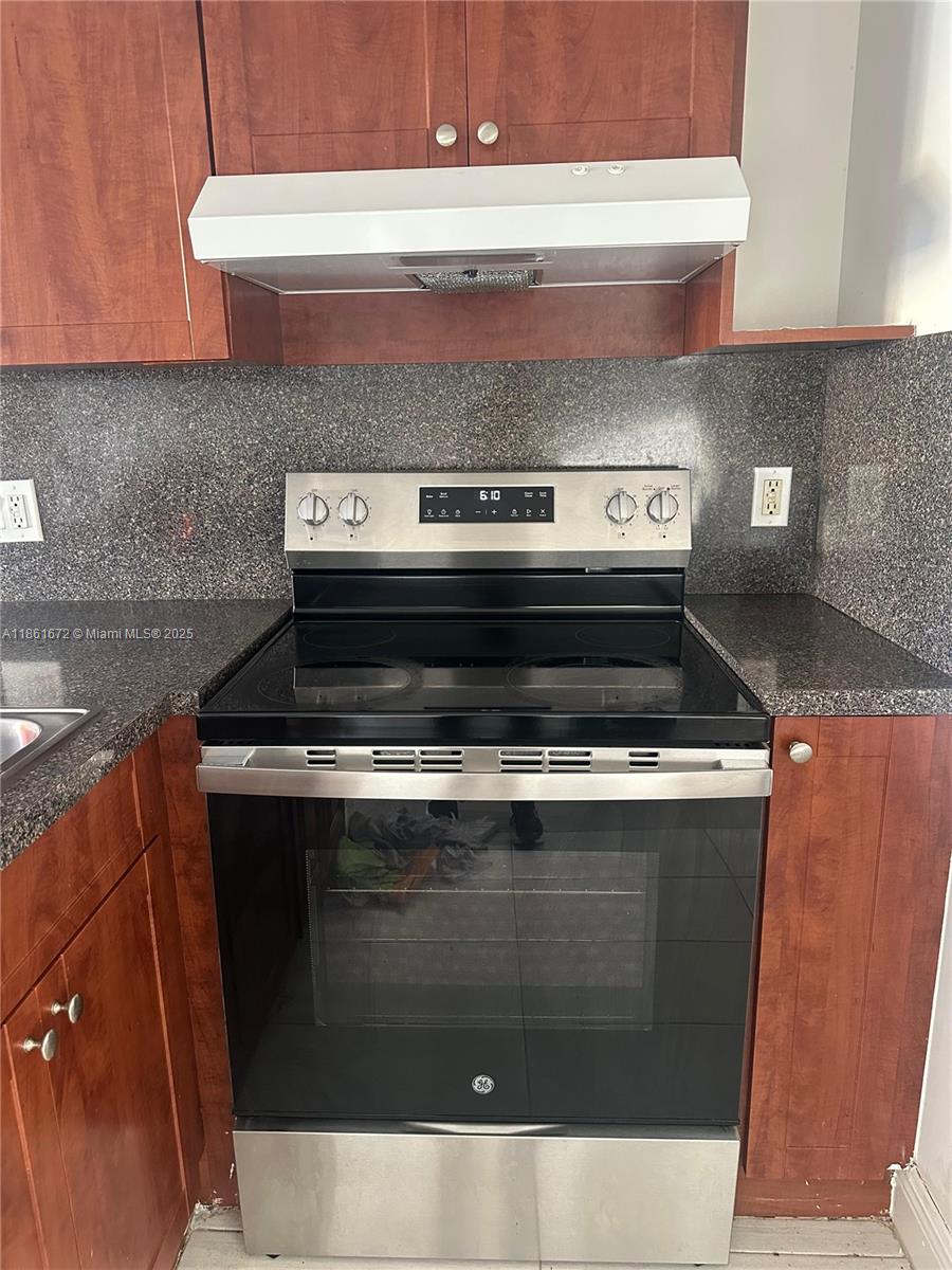 1020 Southwest 4th Street, Unit 106 Miami, FL 33130 - Photo 3 of 10 a stove top oven sitting inside of a kitchen