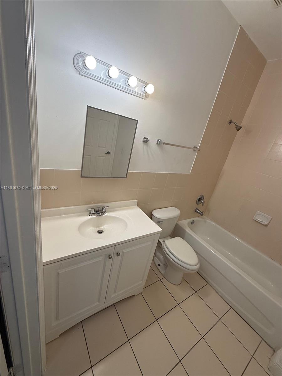 1020 Southwest 4th Street, Unit 106 Miami, FL 33130 - Photo 4 of 10 a bathroom with a sink toilet and tub
