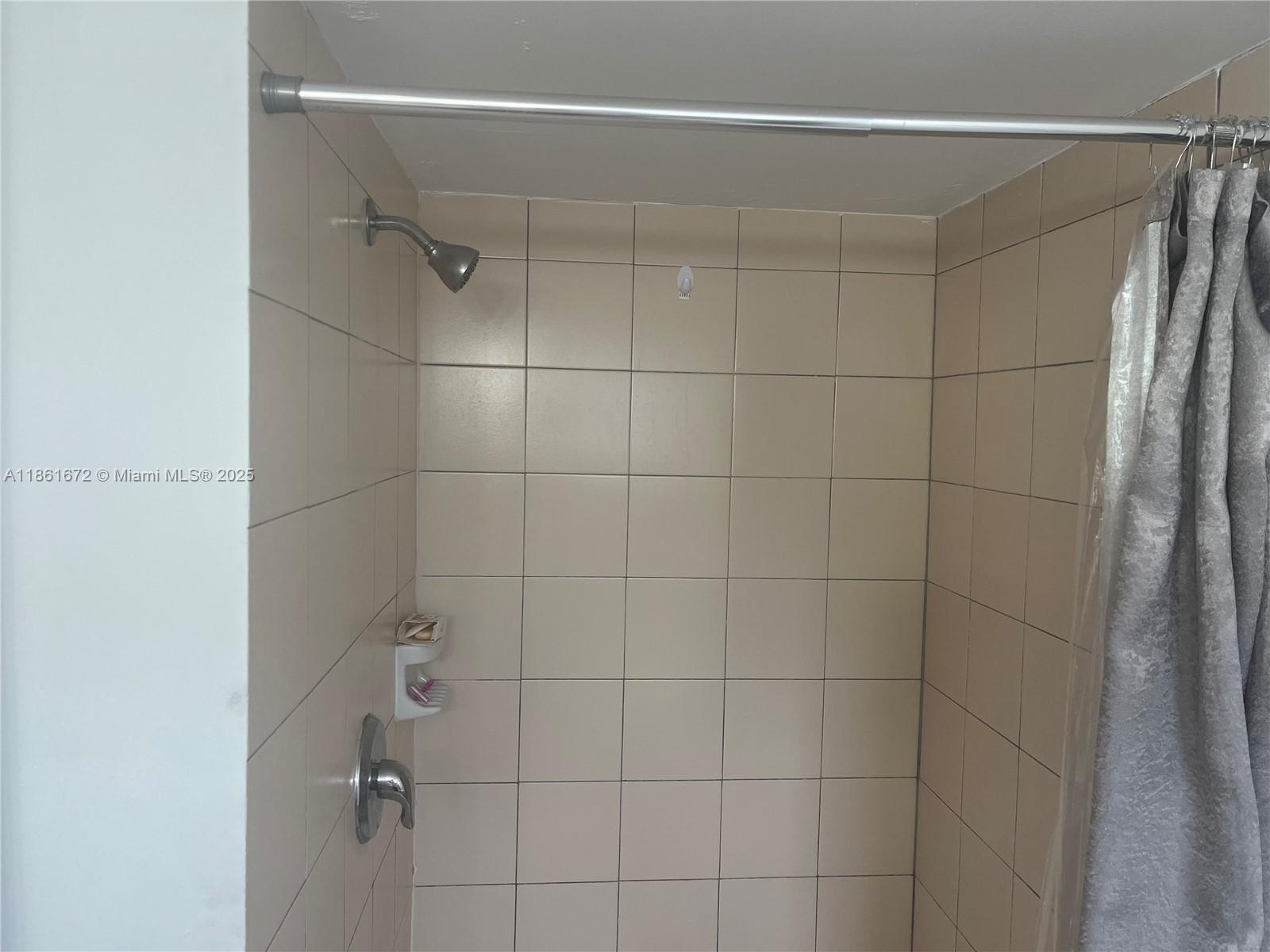 1020 Southwest 4th Street, Unit 106 Miami, FL 33130 - Photo 6 of 10 a bathroom with a shower and a glass door