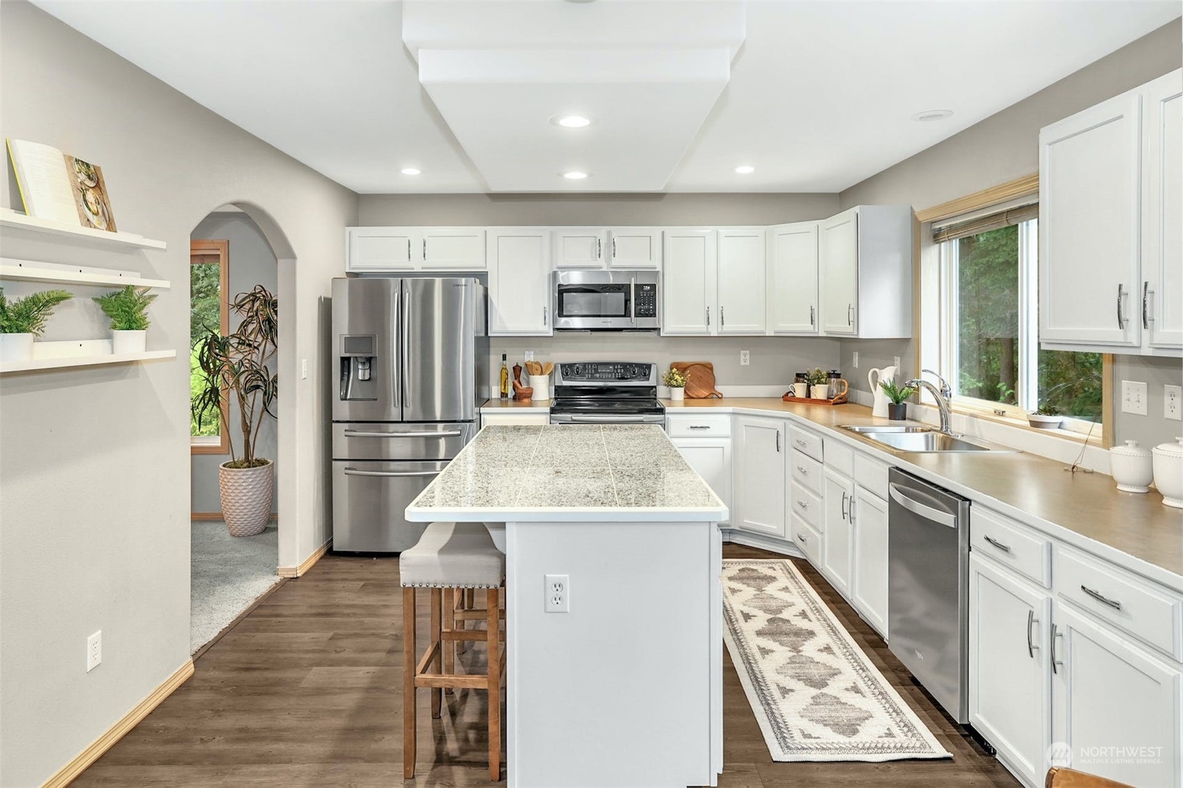 10413 Southeast 186th Place Renton, WA 98055 - Photo 11 of 34 a kitchen with wooden cabinets a sink stove and refrigerator
