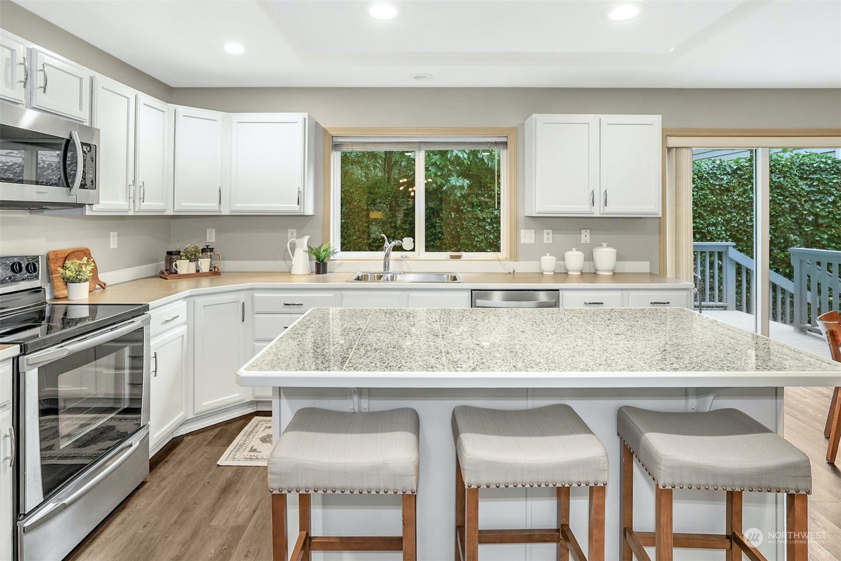 10413 Southeast 186th Place Renton, WA 98055 - Photo 12 of 34 a kitchen with a table chairs sink and cabinets