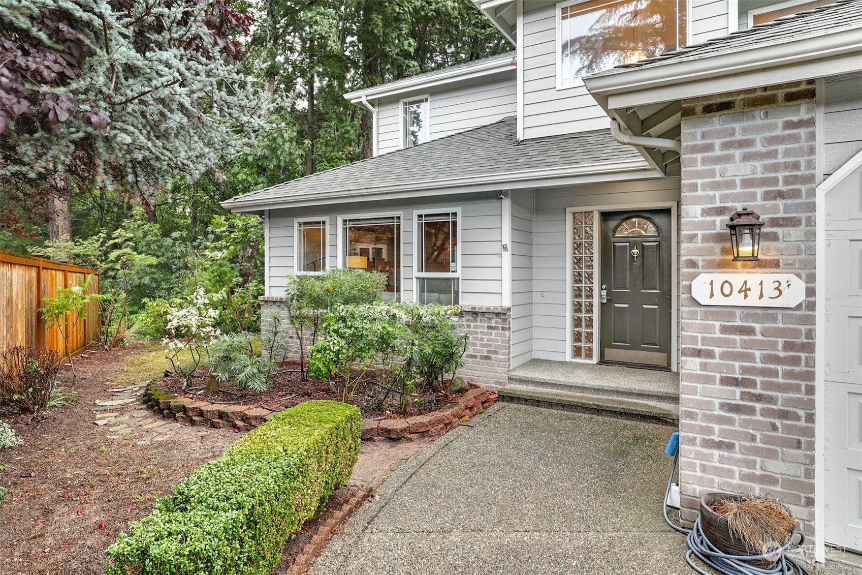 10413 Southeast 186th Place Renton, WA 98055 - Photo 2 of 34 a front view of a house with garden