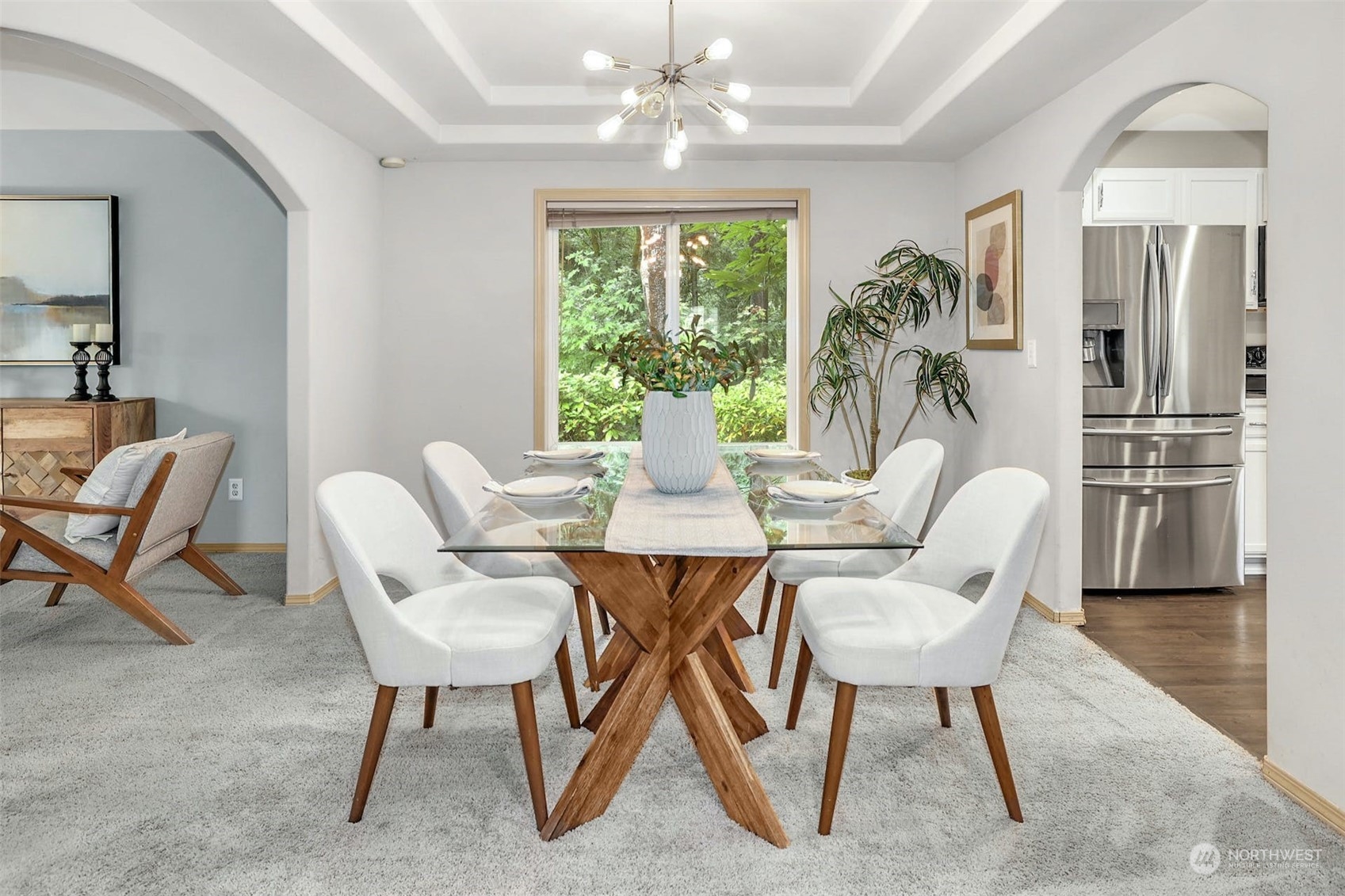 10413 Southeast 186th Place Renton, WA 98055 - Photo 9 of 34 a dining room with furniture a chandelier and wooden floor