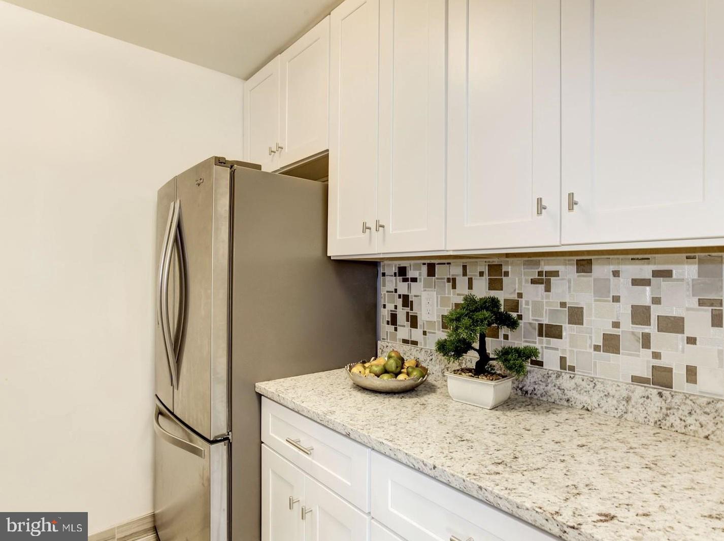 2400 41st Street Northwest, Unit 203 Washington, DC 20007 - Photo 14 of 24 a kitchen with a refrigerator and cabinets