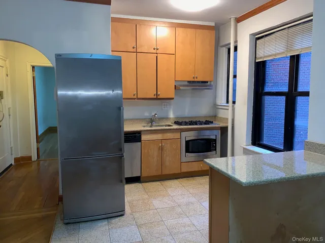 a kitchen with a refrigerator and a stove