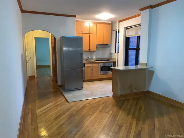 a kitchen with stainless steel appliances granite countertop a refrigerator and a stove