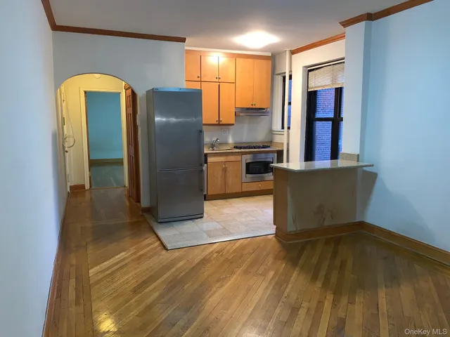 a kitchen with stainless steel appliances granite countertop a refrigerator and a stove