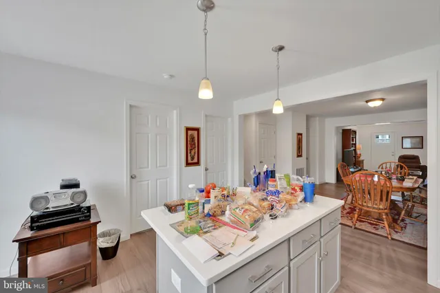 a view of a dining table chairs and chandelier