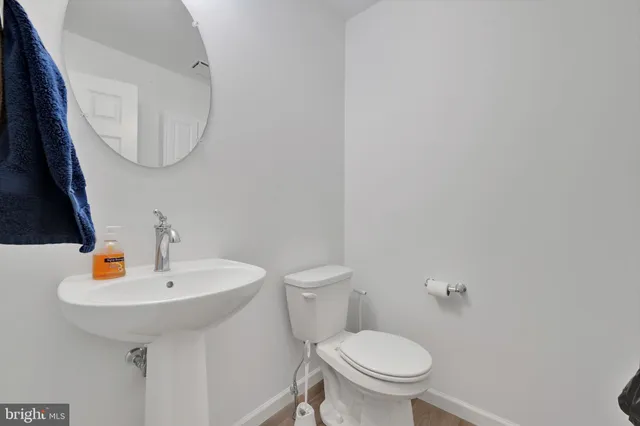 a bathroom with a sink a toilet and mirror