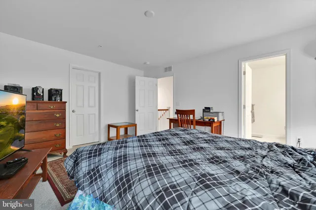 a bedroom with a bed and furniture