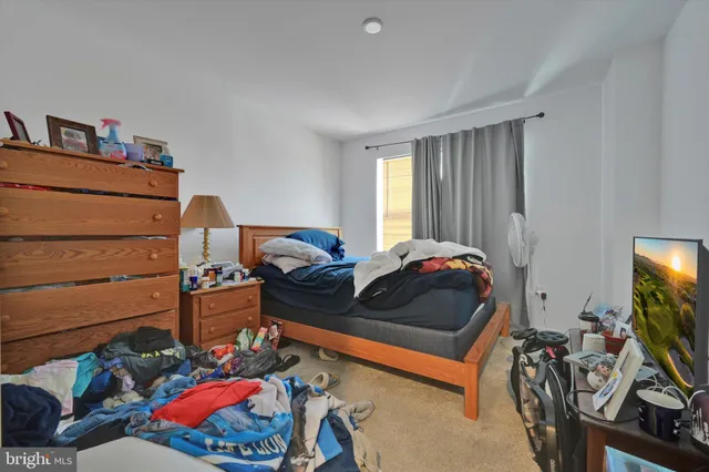 a bedroom with two beds and a flat screen tv