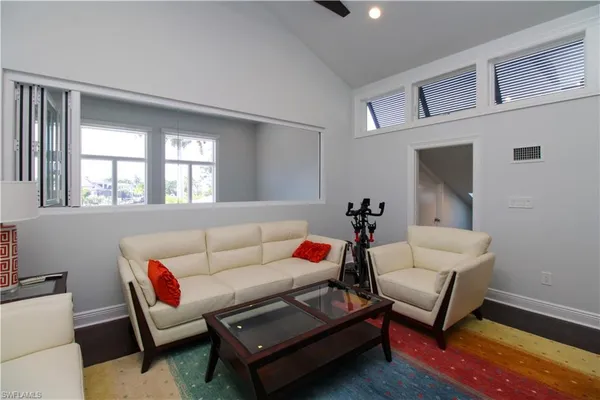 a living room with furniture a rug and a window