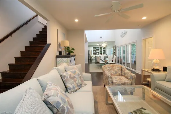 a living room with furniture and wooden floor
