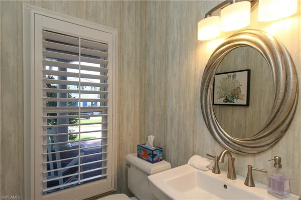 a bathroom with a sink a mirror and a shower