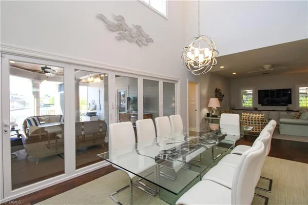 a living room with furniture dining table and a large window